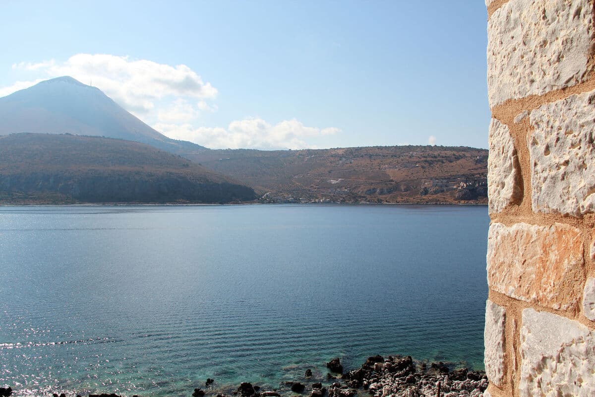 Oitylo bay and Mount Taygetos seen past a stone wall